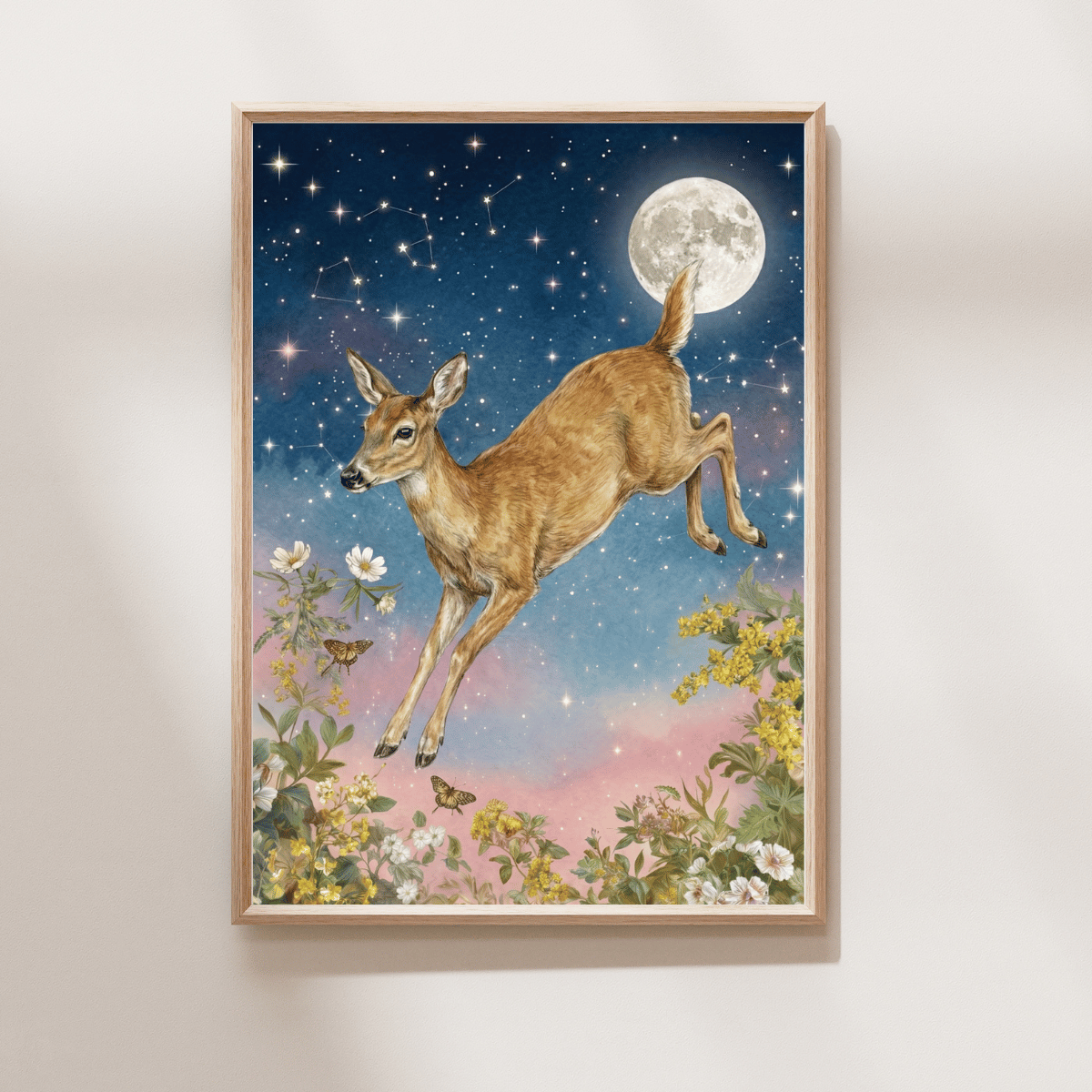 A framed vertical art print featuring a whimsical illustration of a brown deer leaping through flowers under a starry night sky and full moon, hung on a light beige wall.