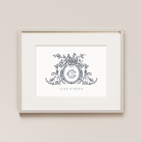 personalized nursery wall art. A serene dark blue crest, embellished with a intricate floral surrounds an ornate scroll and delicate baby animals. The central feature, a baby's initial in an exquisite font, adds a personalised touch, making it a unique and enchanting addition to your nursery decor.