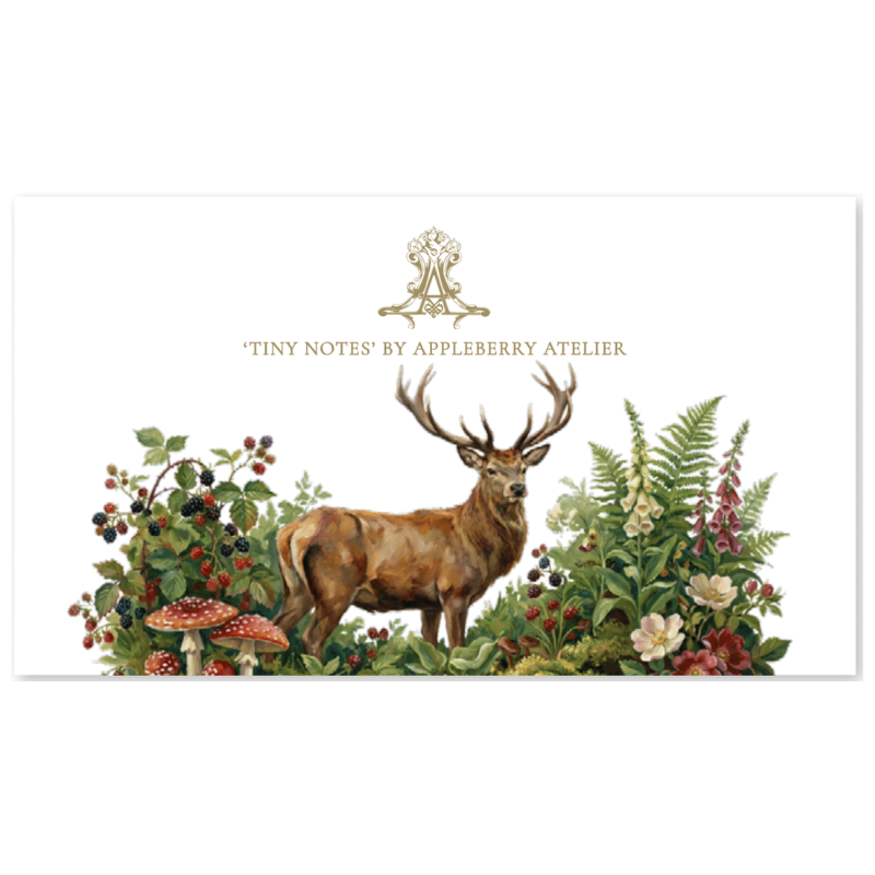 A rectangular white card or print featuring a watercolor-style stag surrounded by wildflowers, berries, and mushrooms, with the text 'TINY NOTES BY APPLEBERRY ATELIER' and a small crest above. The design is centered on a light gray background.