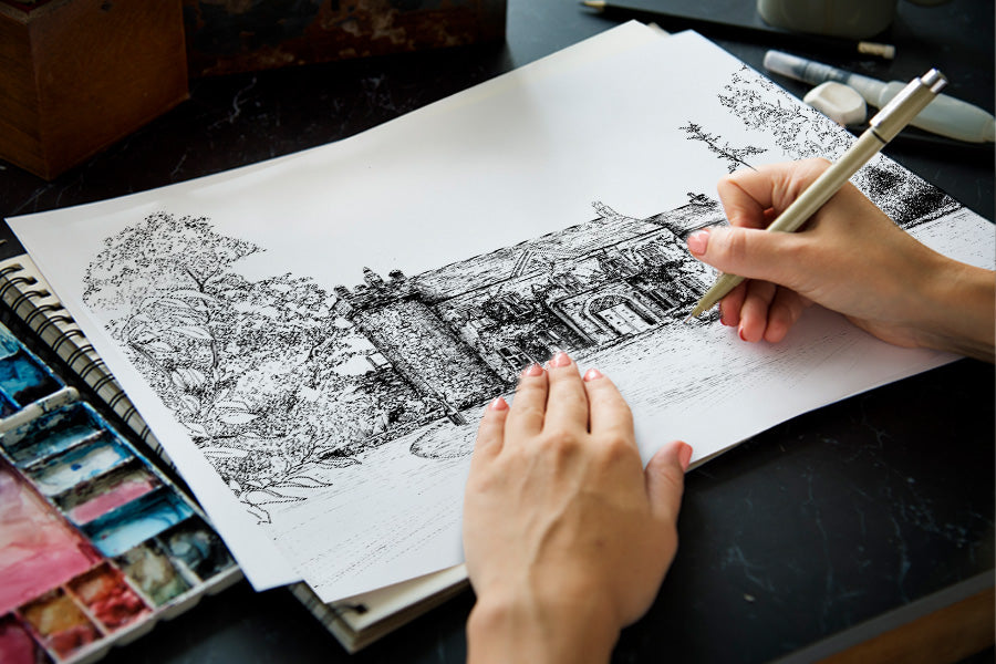 photo of artist hand drawing ink illustration