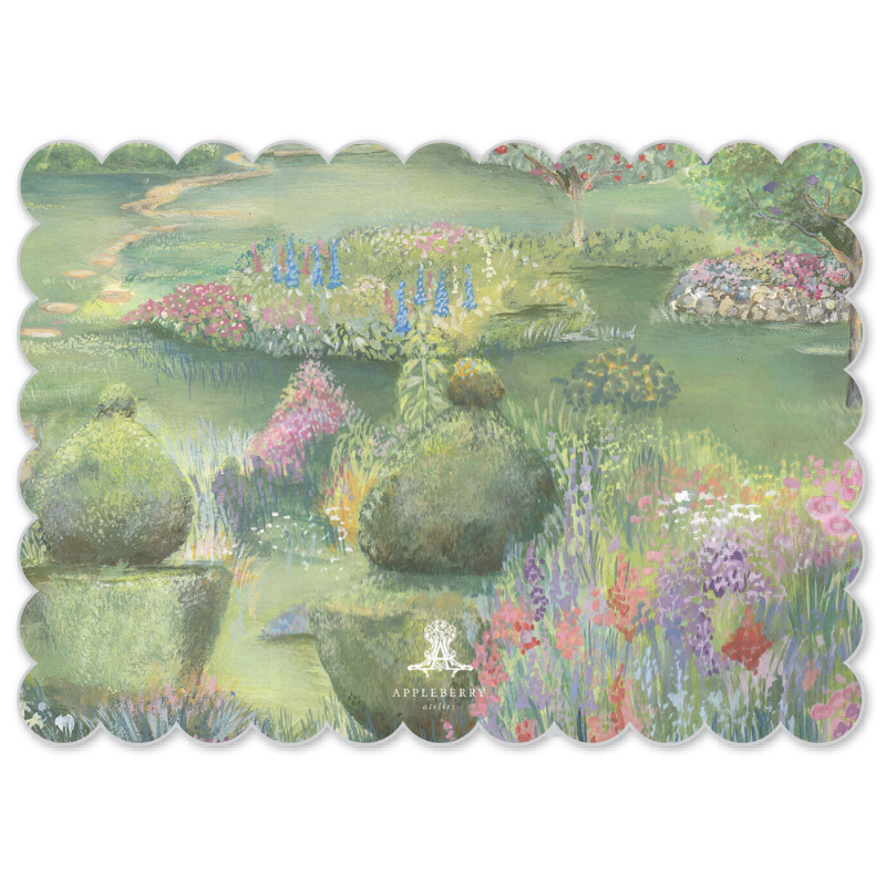 A rectangular placemat with a scalloped edge featuring a pastel garden landscape painting. The artwork depicts a lush green garden with blooming pink, purple, and blue flowers, stone topiary, and a winding path.