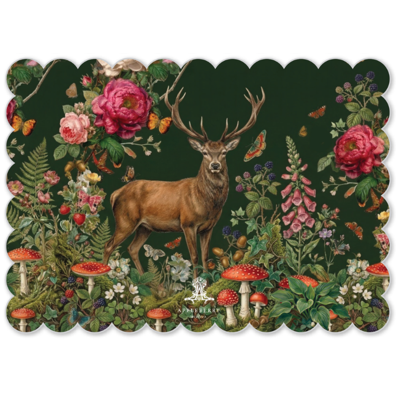 A rectangular placemat with scalloped edges featuring a detailed vintage-style illustration of a stag in a lush forest with pink flowers, red mushrooms, and butterflies on a dark green background.