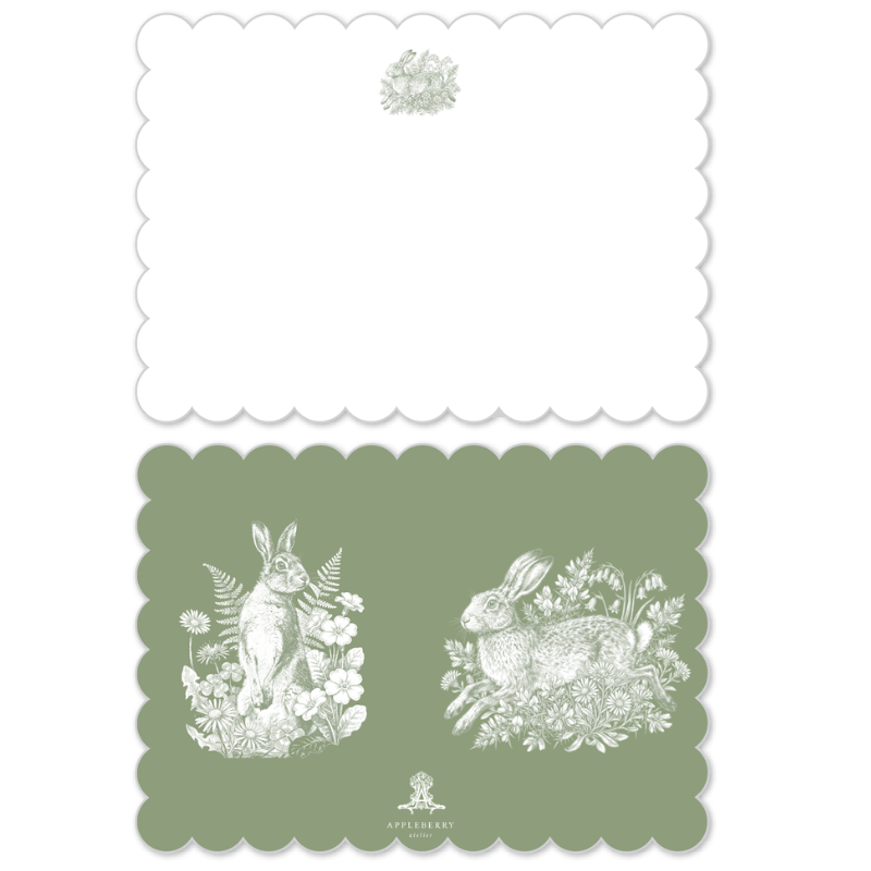 A set of two decorative paper sheets with scalloped edges. The top sheet is white with a small pale green floral motif near the top center.