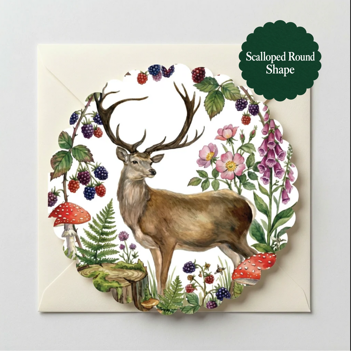 A scalloped round greeting cardfeaturing a watercolor-style deer surrounded by flowers, berries, and mushrooms, shown on a white backing sheet with a dark green badge that reads 'Scalloped Round Shape'.