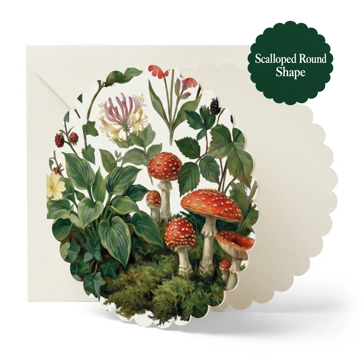 A scalloped round greeting card featuring an illustrated woodland scene with red-and-white mushrooms, green leaves, and small flowers, shown with a white envelope. A dark green badge in the top right reads 'Scalloped Round Shape.